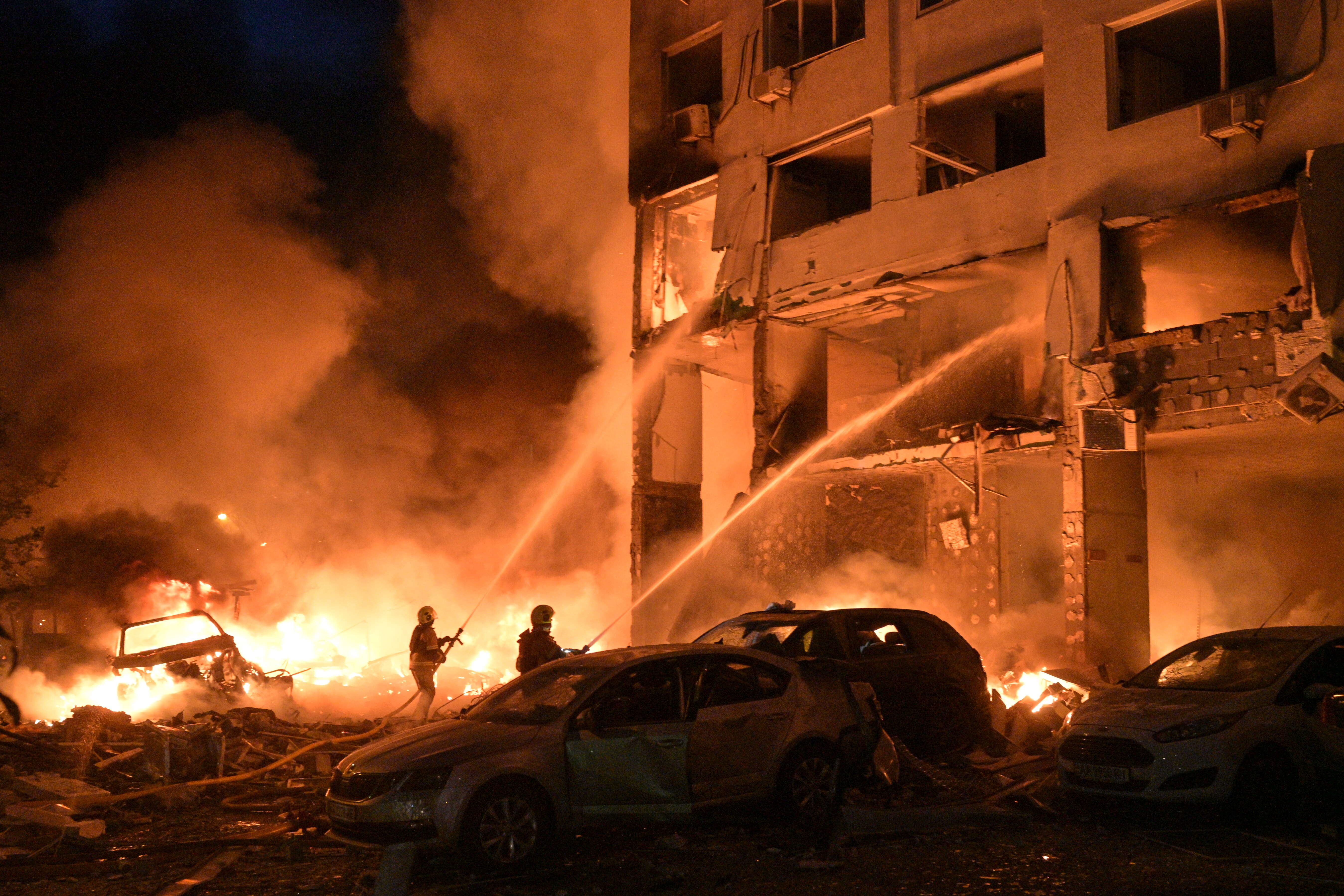 Emergency services personnel work to extinguish a fire following Russian missile attacks in Kyiv, Ukraine, Monday, July 6, 2026.